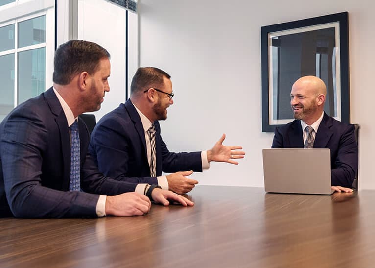 Attorneys of Gold & Gold, P.A. reviewing a case together